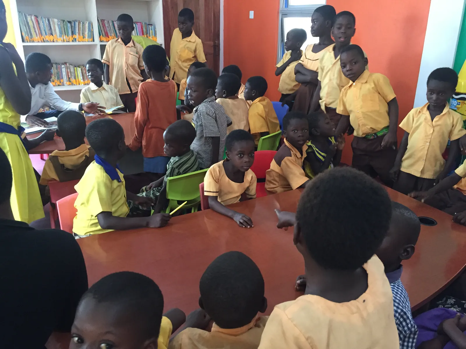 A large group of schoolchildren gathered inside the library