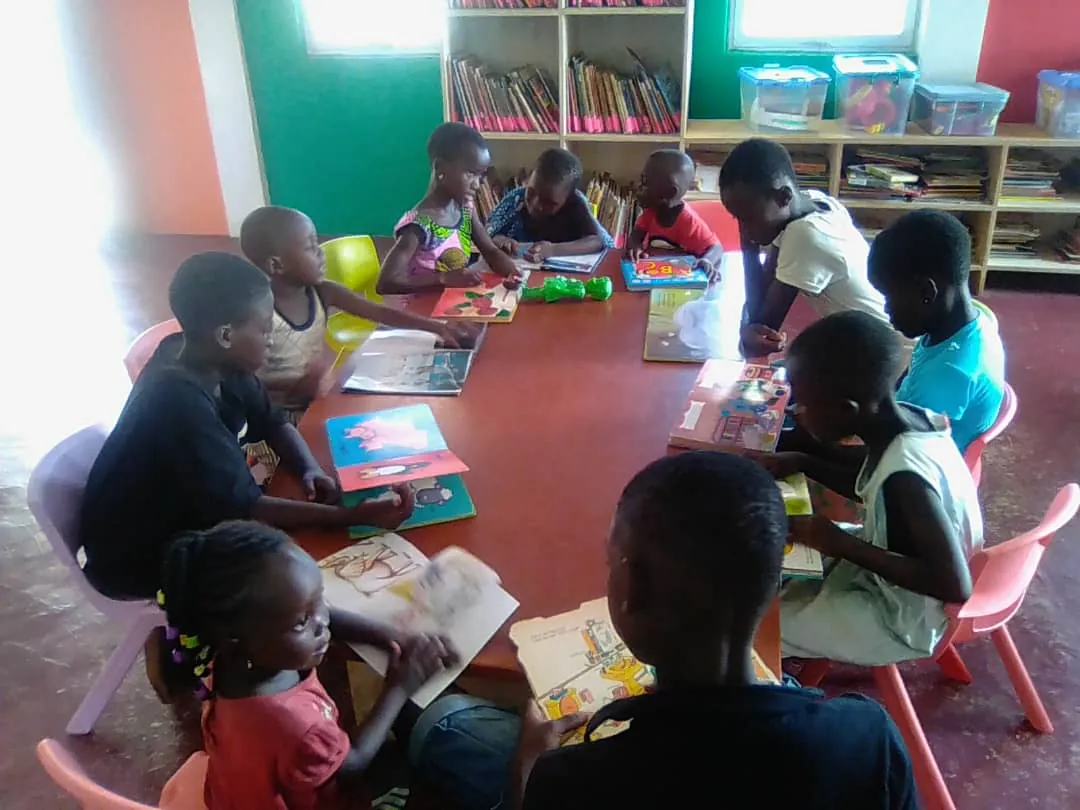 Children looking through picture books at the library