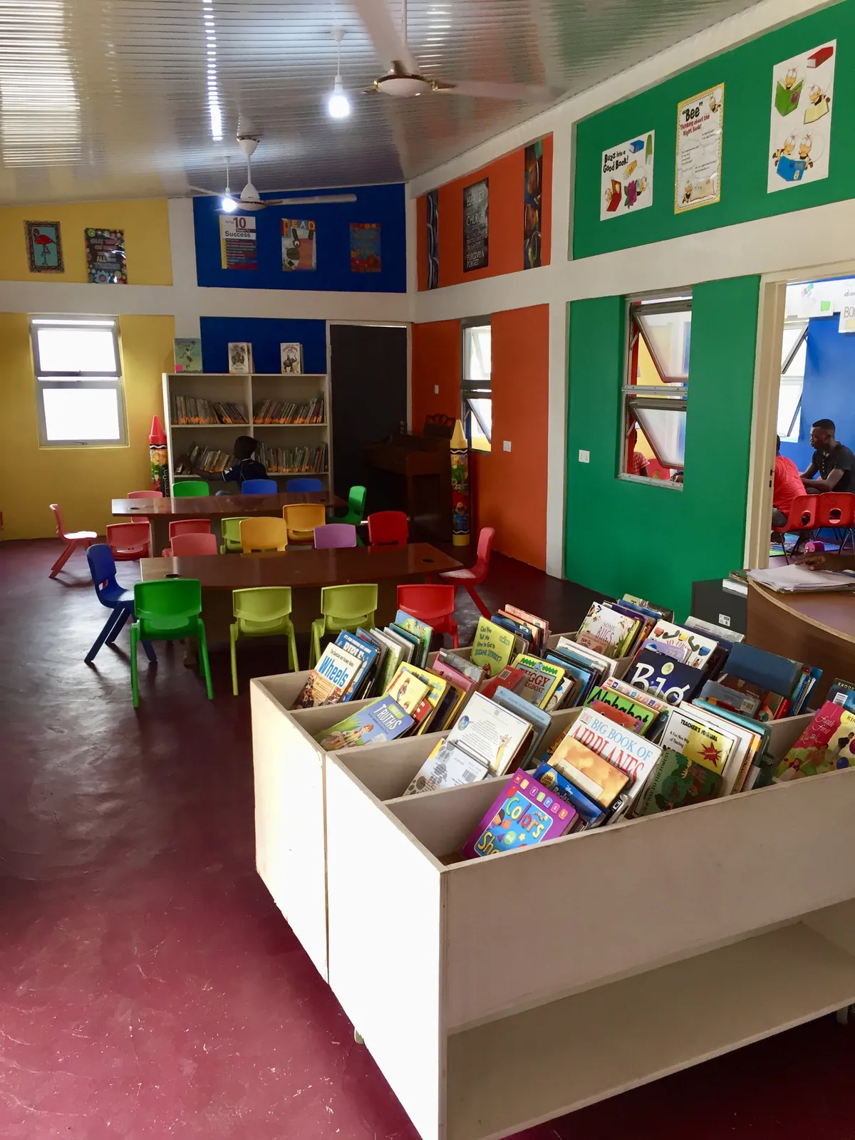 The library's colorful reading room with book bins and small chairs