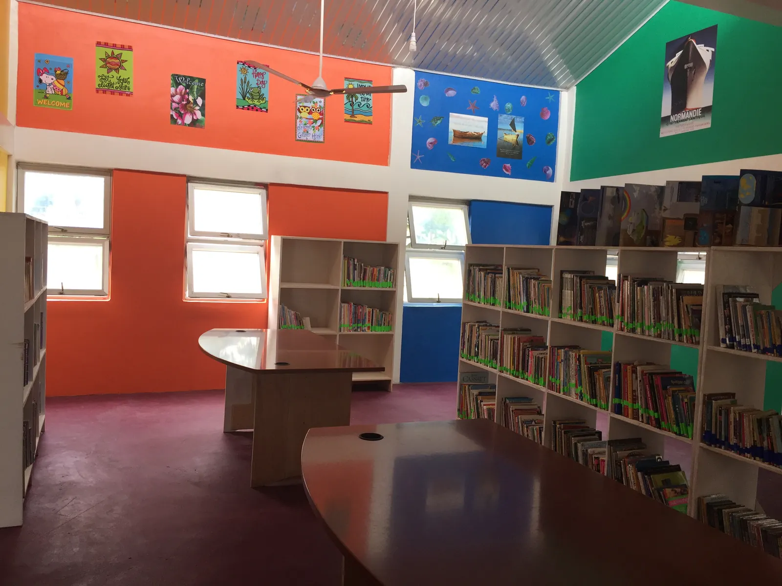 Library shelves filled with books beside reading tables