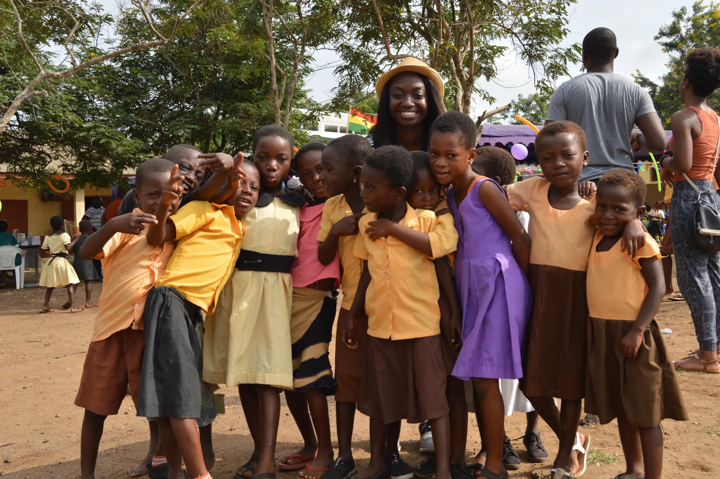 Schoolchildren and adults gathered together outdoors